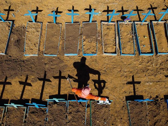 A gravedigger at the Nossa Senhora Aparecida cemetery where COVID-19 victims are buried daily, in the neighbourhood of Taruma, in Manaus, Brazil. Picture: AFP