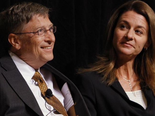 Bill Gates, left, smiles with his wife Melinda Gates, during a ceremony honoring the couple with the 2010 J. William Fulbright Prize for International Understanding at the Library of Congress in Washington, on Friday, Oct. 15, 2010. (AP Photo/Jacquelyn Martin)