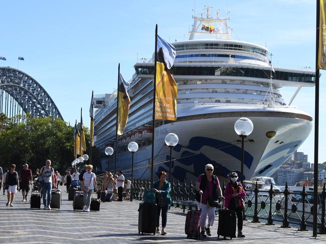 Cruise ship passengers disembark from the Princess Cruises owned Ruby Princess at Circular Quay in Sydney, Thursday, March 19, 2020. (AAP Image/Dean Lewins) NO ARCHIVING