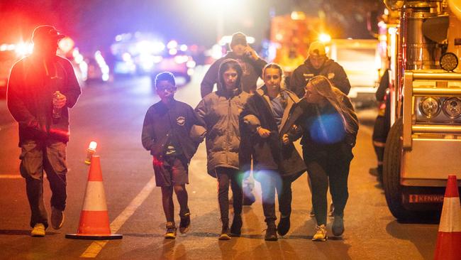 Children and parents leave the scene of the crash on Tuesday evening. Picture: Jake Nowakowski