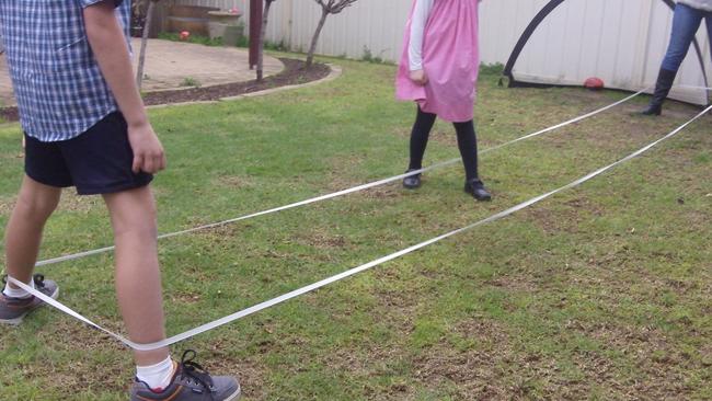 Children playing elastics.