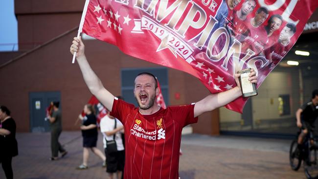 A Liverpool fan celebrates at Anfield after the club claimed the Premier League title. Picture: Getty Images