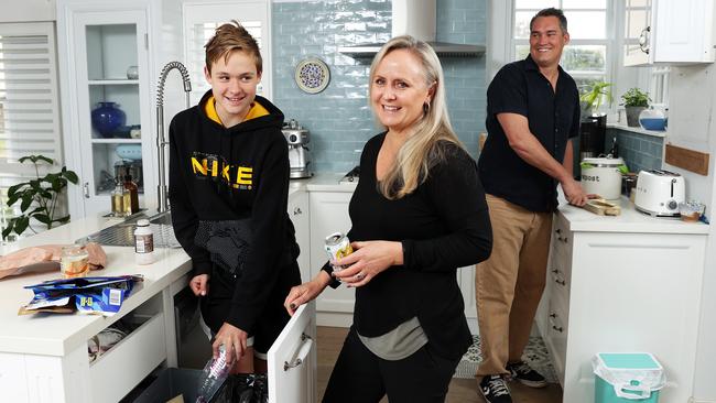 Lara and Iain Barclay with their son Tane, 12, recycling in their kitchen. Picture: Tim Hunter