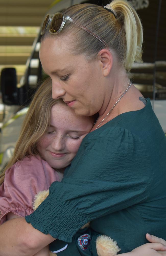 Madison Jennings with her mother Tinneile embracing after Madison accepted her certificate of appreciation at Mackay South Ambulance station after rescuing her cousin from drowning. Picture: Lillian Watkins