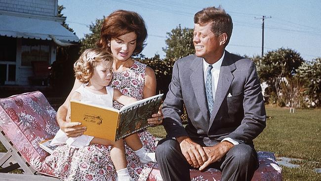 Jacqueline Kennedy and her husband Senator John F. Kennedy reading to their daughter Caroline. Picture: Supplied