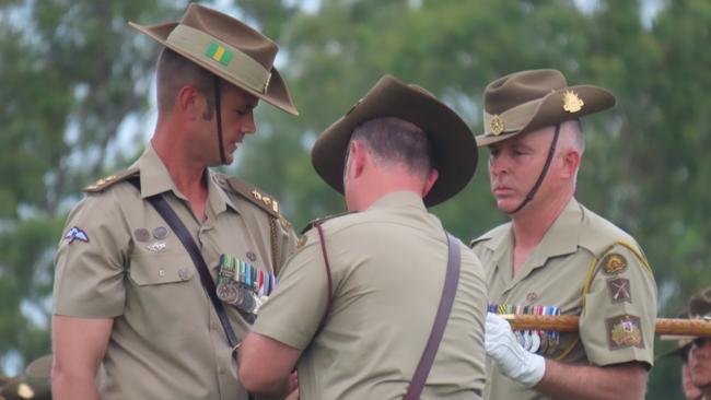 Lieutenant Colonel Hugh Grogan (left) receives a new lanyard as part of the formalities. Picture: Harry Brill.