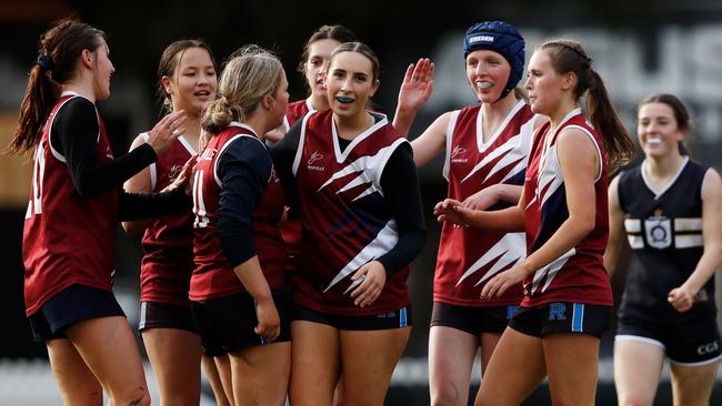 Georgia Knight of Rowville Secondary celebrates a goal with teammates. Picture: Dylan Burns/AFL Photos via Getty Images