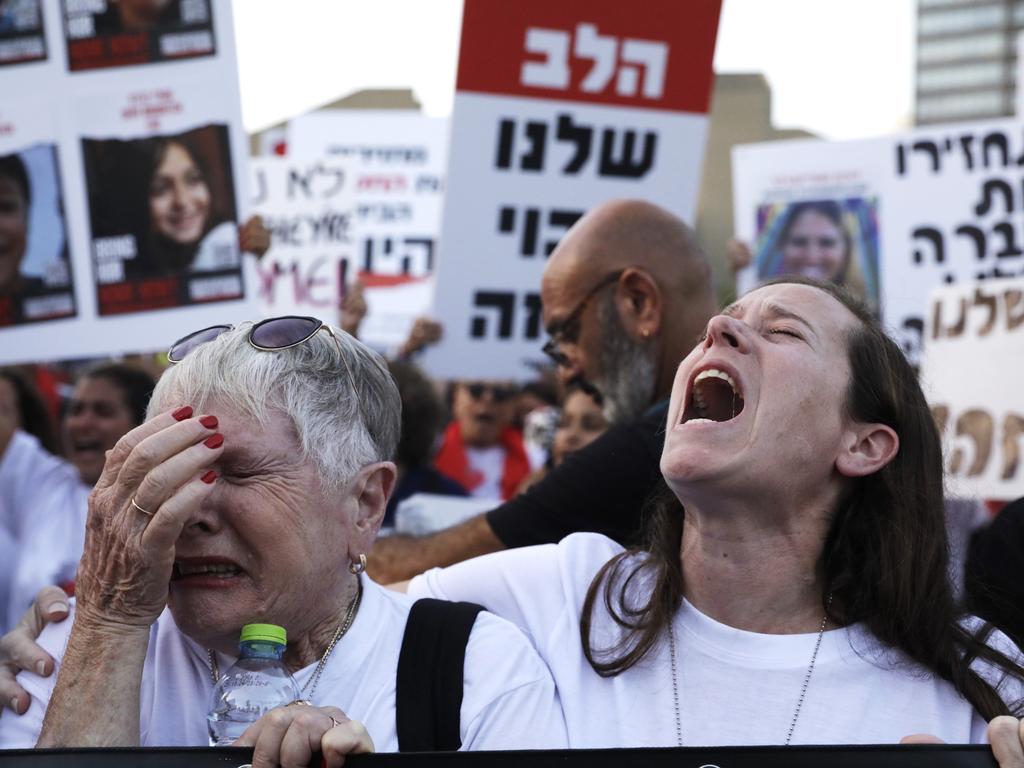A woman weeps and another shouts as family and friends of hostages taken from Kfar Aza demonstrate in Tel Aviv museum plaza. Picture: Amir Levy/Getty Images