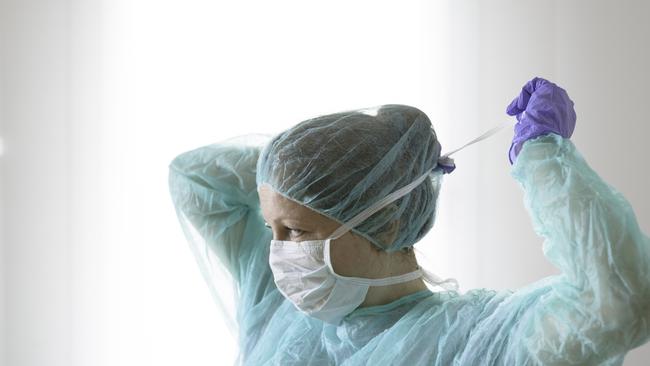 Nurse wearing protective mask and gloves. Istock