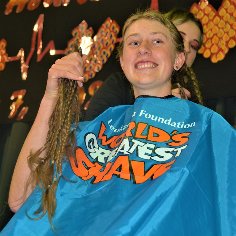 At the St Joseph's College 2023 World's Greatest Shave event is student Emily Chandler getting her hair cut by her support crew and hairdresser Natalie Schmidt from the Hair Room on Russell. Picture: Rhylea Millar