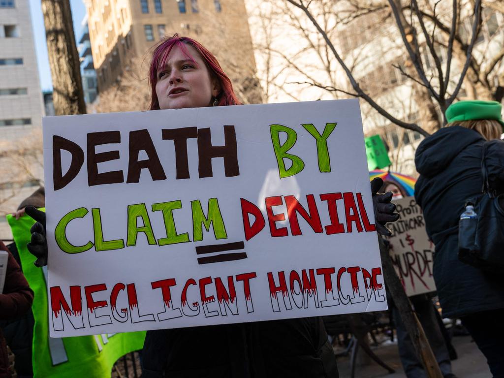 Supporters wear green and hold placards denouncing America’s health care system. Picture: Spencer Platt / Getty via AFP