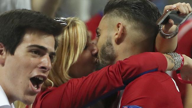Atletico's Yannick Carrasco gets a kiss as he celebrates after scoring.
