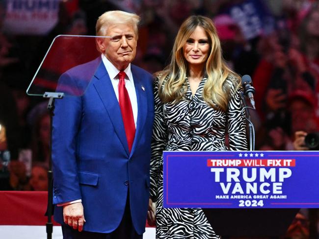 Former US president Donald Trump with wife Melania on stage. Picture: AFP