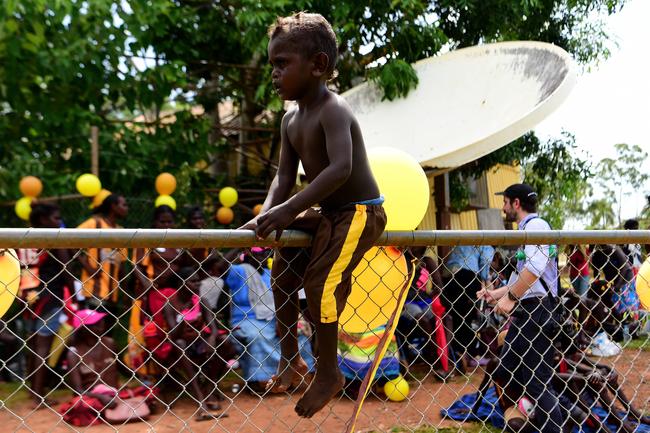 A young Tapalinga Superstars fan jumps onto the field during quarter time during grand final match against the Ranku Eagles on Sunday during this year's 49th Annual Tiwi Grand Final on Bathurst Island which is part of the Tiwi Islands chain, north of Darwin, NT. Picture: Justin Kennedy