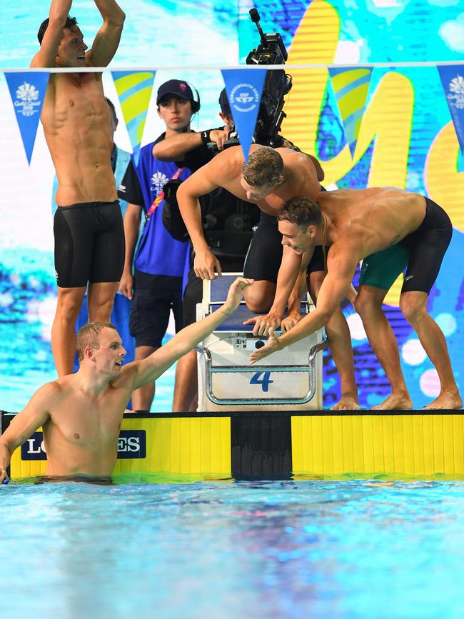 Australia's Kyle Chalmers is congratulated by teammates Mitch Larkin, Jake Packard and Grant Irvine after their 4x100m medley relay win. Photo: AFP