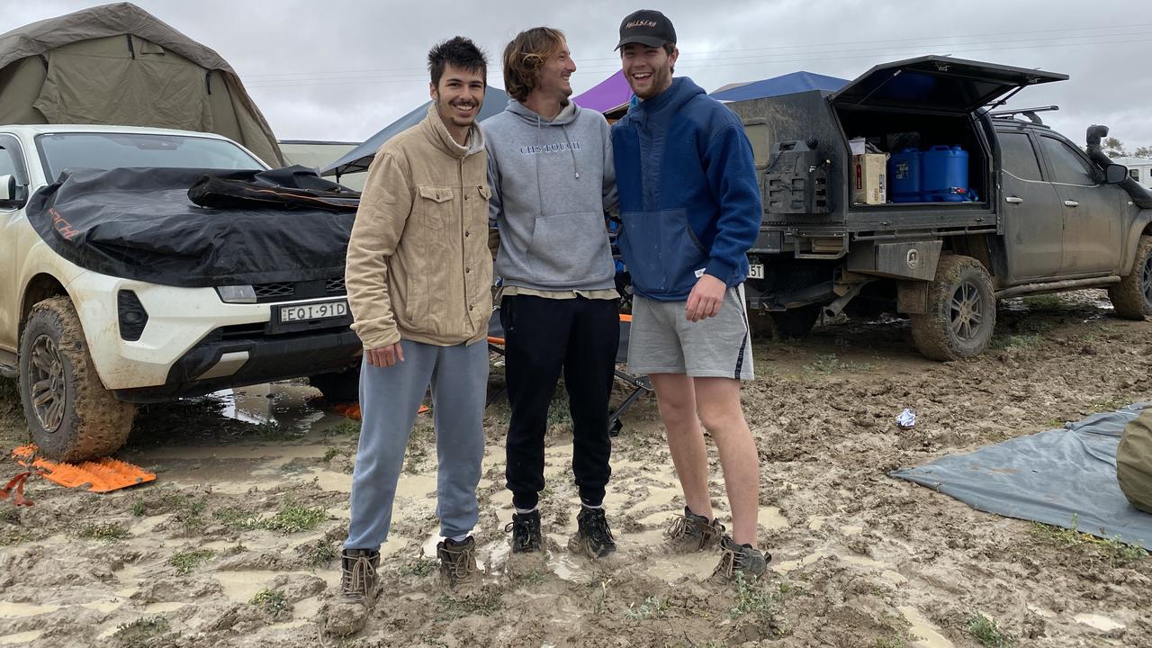 Revellers show off their campsite, which went from dust to mud in a matter of hours.