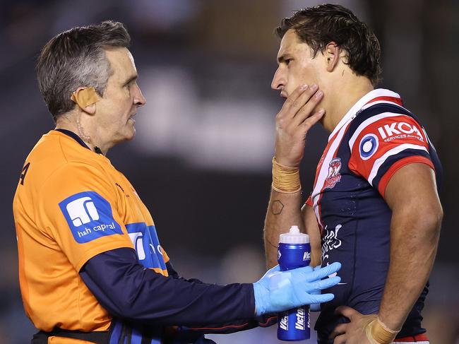 SYDNEY, AUSTRALIA - SEPTEMBER 09:  Sandon Smith of the Roosters is attended to by a team trainer during the NRL Elimination Final match between Cronulla Sharks and Sydney Roosters at PointsBet Stadium on September 09, 2023 in Sydney, Australia. (Photo by Mark Metcalfe/Getty Images)