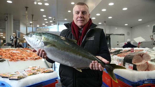 David Head, Clean Seas chief executive, holding a Yellowtail Kingfish at the Sydney Fish Market. Picture: BRITTA CAMPION/The Australian