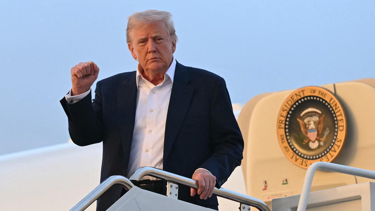 Mr Trump offers a fist pump while disembarking from Air Force One. Picture: Saul Loeb