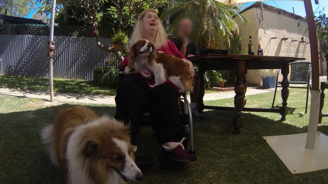 Annie Smith at a social gathering in 2011, with her dogs Maggie and Deana.