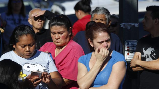 Parents wait for news of students at a school in Los Angeles after two students were shot and wounded, one critically. Picture: Damian Dovarganes
