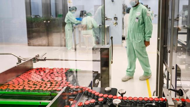 A laboratory technician supervises capped vials during filling and packaging tests for the large-scale production and supply of the University of Oxford‘s COVID-19 vaccine. Picture: AFP