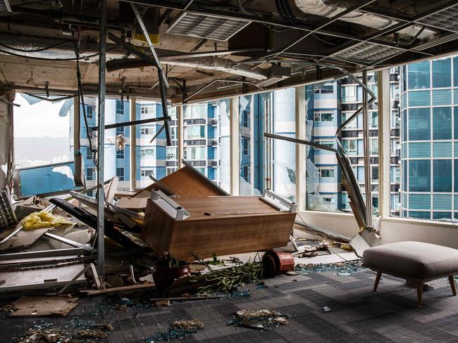 Panels and debris from a collapsed ceiling are seen with blown over pieces of furniture in a company office in Hong Kong. Picture: AFP