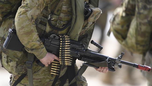 BOWEN, AUSTRALIA - JULY 22: An Australian infantry soldier from 2 RAR (Royal Australian Regiment) walks along the beach after disembarking in an amphibious operation on July 22, 2019 in Bowen, Australia.