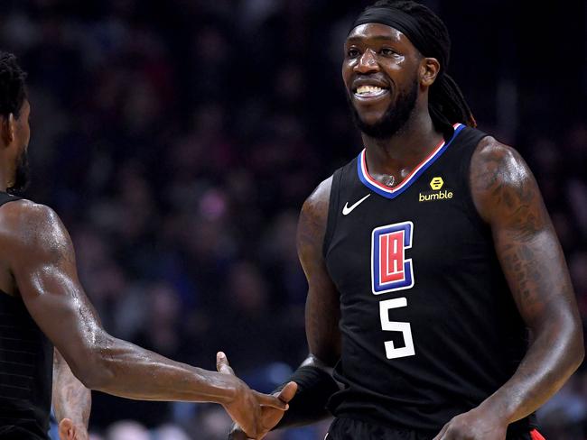 LOS ANGELES, CALIFORNIA - FEBRUARY 25: Montrezl Harrell #5 of the LA Clippers celebrates his dunk with Patrick Beverley #21 after a Dallas Mavericks timeout during the first half at Staples Center on February 25, 2019 in Los Angeles, California.   Harry How/Getty Images/AFP == FOR NEWSPAPERS, INTERNET, TELCOS & TELEVISION USE ONLY ==