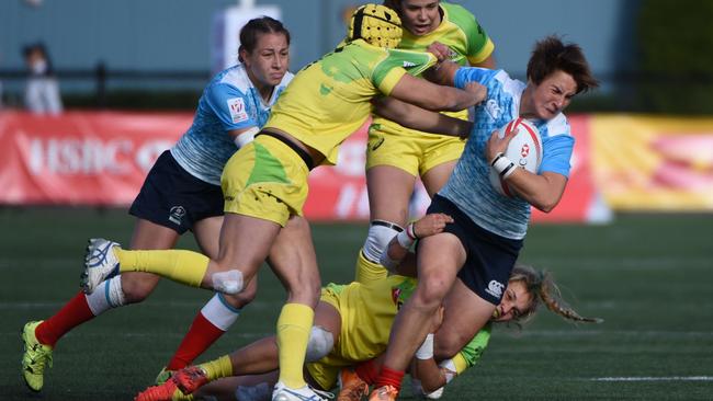 Australia (yellow) vs Russia (blue)action on the first day of HSBC World Rugby Women's Sevens Series, in Langford, BC, on April 16, 2016. / AFP PHOTO / Don MacKinnon