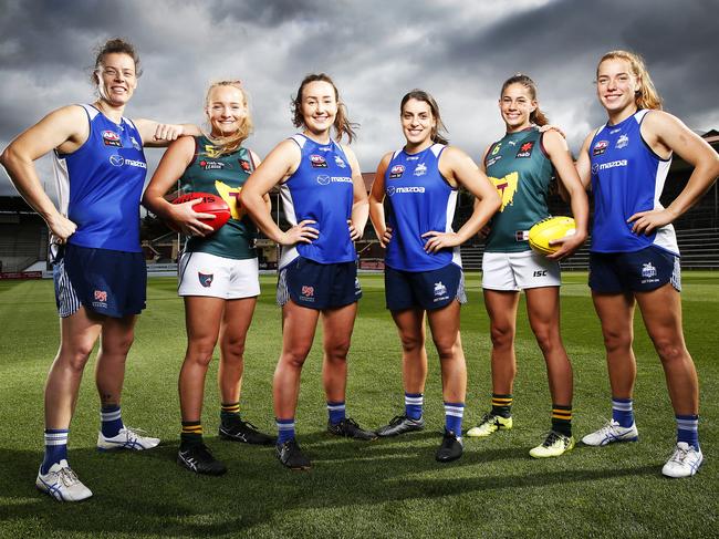 Tasmanian Devils under 18's players Brianna Oates, 17 and Tahlia Bortignon, 19 alongside Tasmanian AFLW Kangaroos players LR Britt Gibson, Nicole Bresnehan, Ellie Gavalas and Mia King ahead of today's games at North Hobart oval. Picture: Zak Simmonds