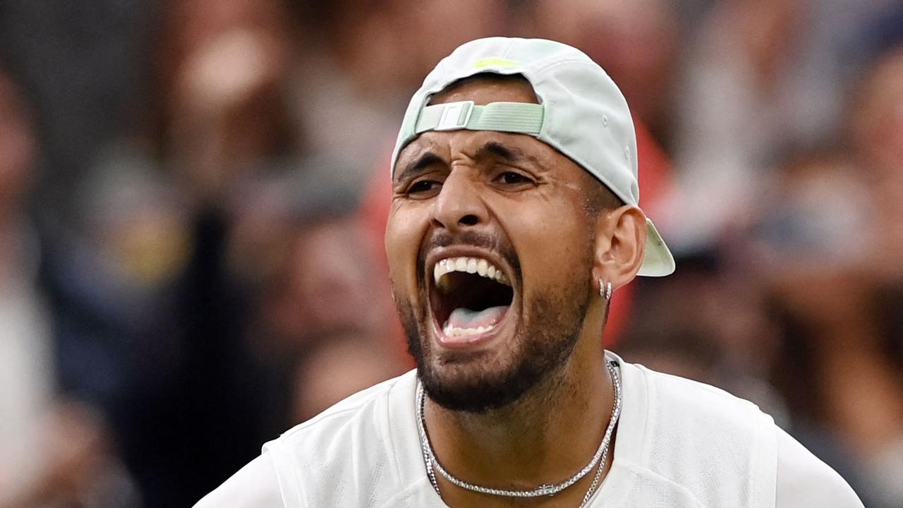 TOPSHOT – Australia's Nick Kyrgios celebrates beating Greece's Stefanos Tsitsipas during their men's singles tennis match on the sixth day of the 2022 Wimbledon Championships at The All England Tennis Club in Wimbledon, southwest London, on July 2, 2022. (Photo by Glyn KIRK / AFP) / RESTRICTED TO EDITORIAL USE