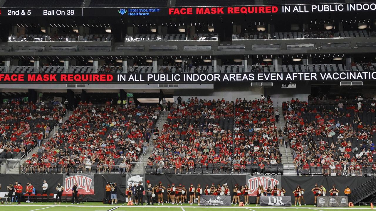 Video screens display a message about required mask wearing after Covid-19 vaccinations during a game between the Eastern Washington Eagles and the UNLV Rebels at Allegiant Stadium in Las Vegas, Nevada. Picture: Ethan Miller/Getty Images