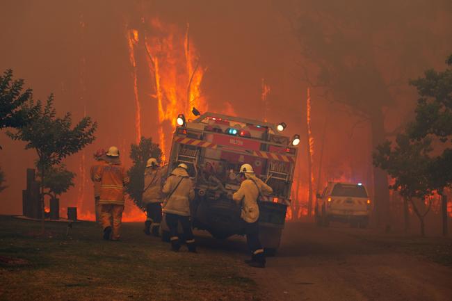 RFS Firefighters desperately worked to save homes on Willinga Drive at Bawley Point. Picture: Gary Ramage