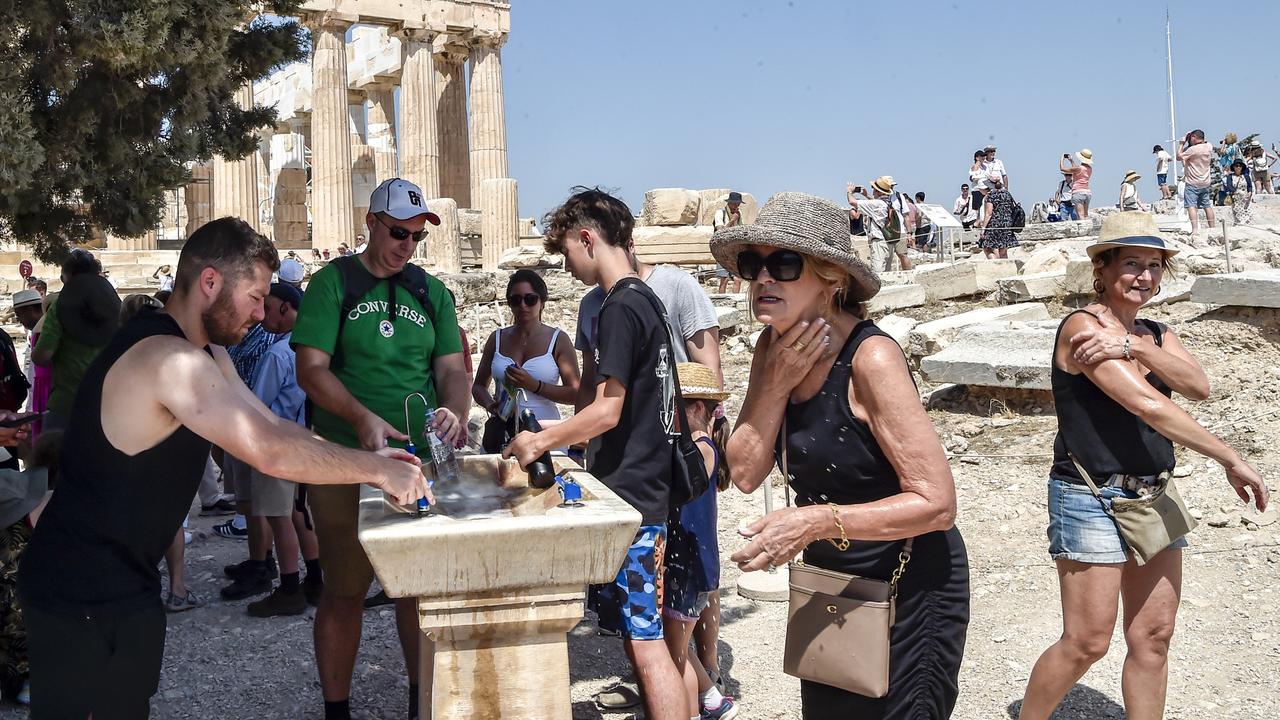 Tourists try to cool down in front of the Parthenon temple at the Acropolis in Greece during a heatwave on July 20. Picture: Milos Bicanski/Getty Images