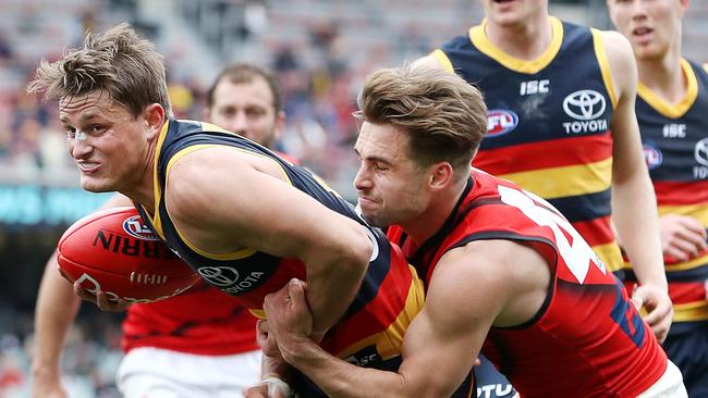 Will Snelling tackles Adelaide midfielder Matt Crouch. Picture: Sarah Reed