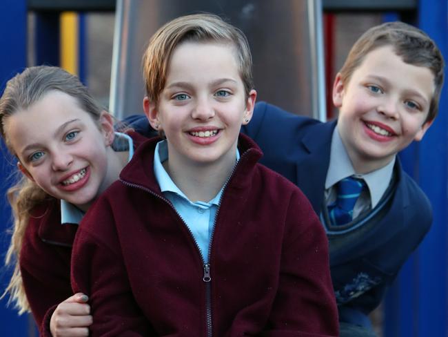 Ali Mountifield with her triplet 12-year-olds - two girls and a boy .Lucy, Hannah, and Oscar Smit in Canberra.Oscar, goes to a different school than his sisters and Ali is considering sending the girls to different schools next year. For a story on class sizes for Monday's paper (Sept 16). Picture Kym Smith