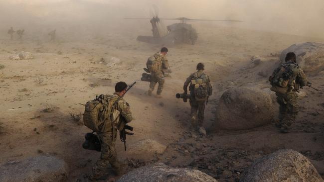 Special Operations Task Group soldiers make their way to a waiting UH-60 Blackhawk helicopter as part of clearance operations removing Taliban insurgents from Afghan communities. Picture: Supplied