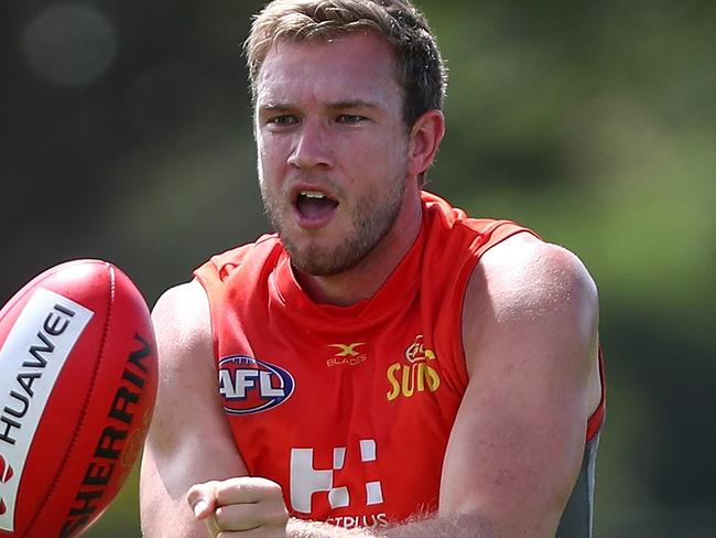 GOLD COAST, AUSTRALIA - MARCH 08:  Sam Day handballs during a Gold Coast Suns AFL training session at Bond University AFL Field on March 8, 2018 in Gold Coast, Australia.  (Photo by Chris Hyde/Getty Images)