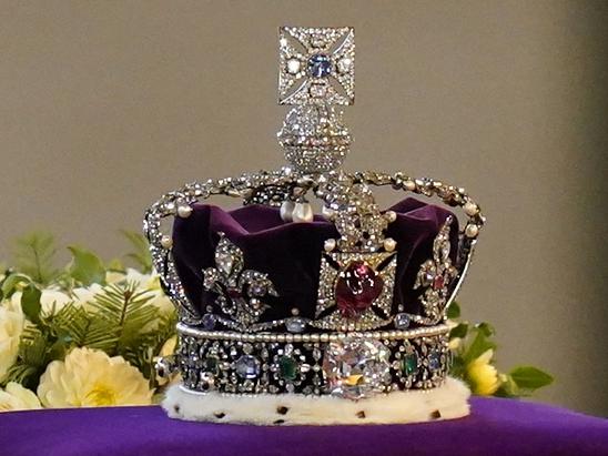 The coffin of Queen Elizabeth II, draped in a Royal Standard and adorned with the Imperial State Crown, is pictured inside Westminster Hall, at the Palace of Westminster, where it will Lie in State, in London on September 14, 2022. - Queen Elizabeth II will lie in state in Westminster Hall inside the Palace of Westminster, from Wednesday until a few hours before her funeral on Monday, with huge queues expected to file past her coffin to pay their respects. (Photo by Jacob King / POOL / AFP)