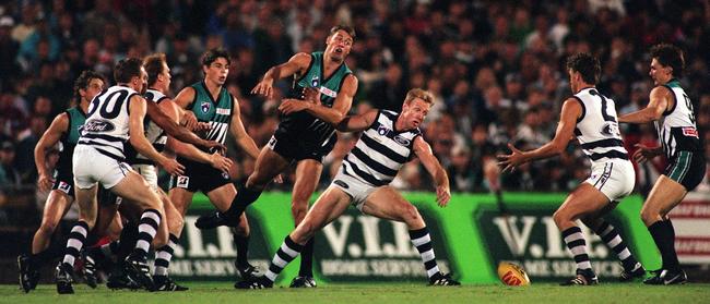 Matthew Primus competes against Barry Stoneham in the ruck as Port would go on to record their first AFL victory.