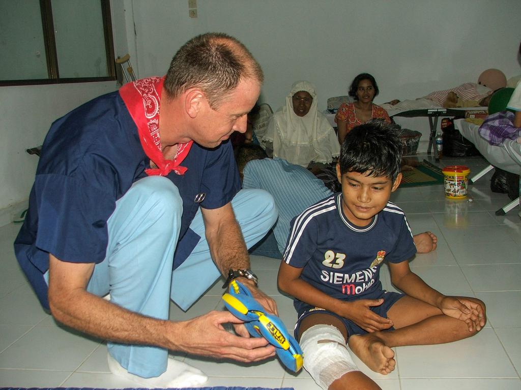 Dave Tingey with a young patient at Fakinah Hospital. Picture: Supplied