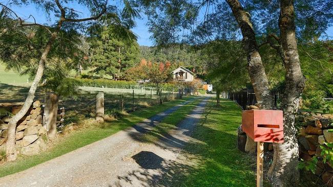 This NSW house has 12 bodies buried behind the black fencing on the right.