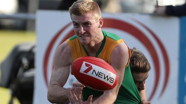 WRFL footy: Spotswood v Sunshine. Spotswood's Josh Drage releases a handball. Picture: LOCAL LEGENDS PHOTOGRAPHY