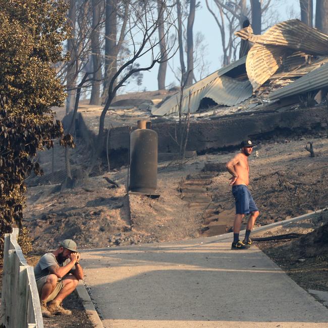 Utterly devastated ... Tathra locals survey the remnants of the scene. Picture: Ray Strange