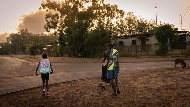 A student walks home from school with her mother at Angurugu on Groote Eylandt. Picture: Rebecca Parker