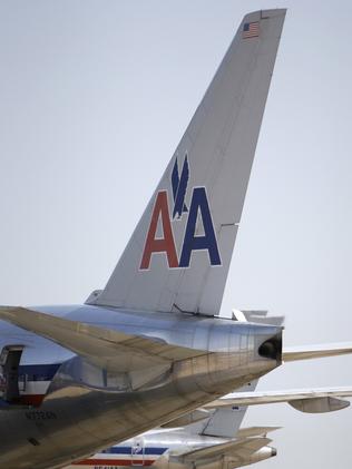 In this June 29, 2011 photo, American Airlines aircraft sit at Terminal D gates at Dallas-Fort Worth International Airport, in Grapevine, Texas. American Airlines and American Eagle's parent companies are filing for Chapter 11 bankruptcy protection Tuesday, Nov. 29, 2011.(AP Photo/Tony Gutierrez)