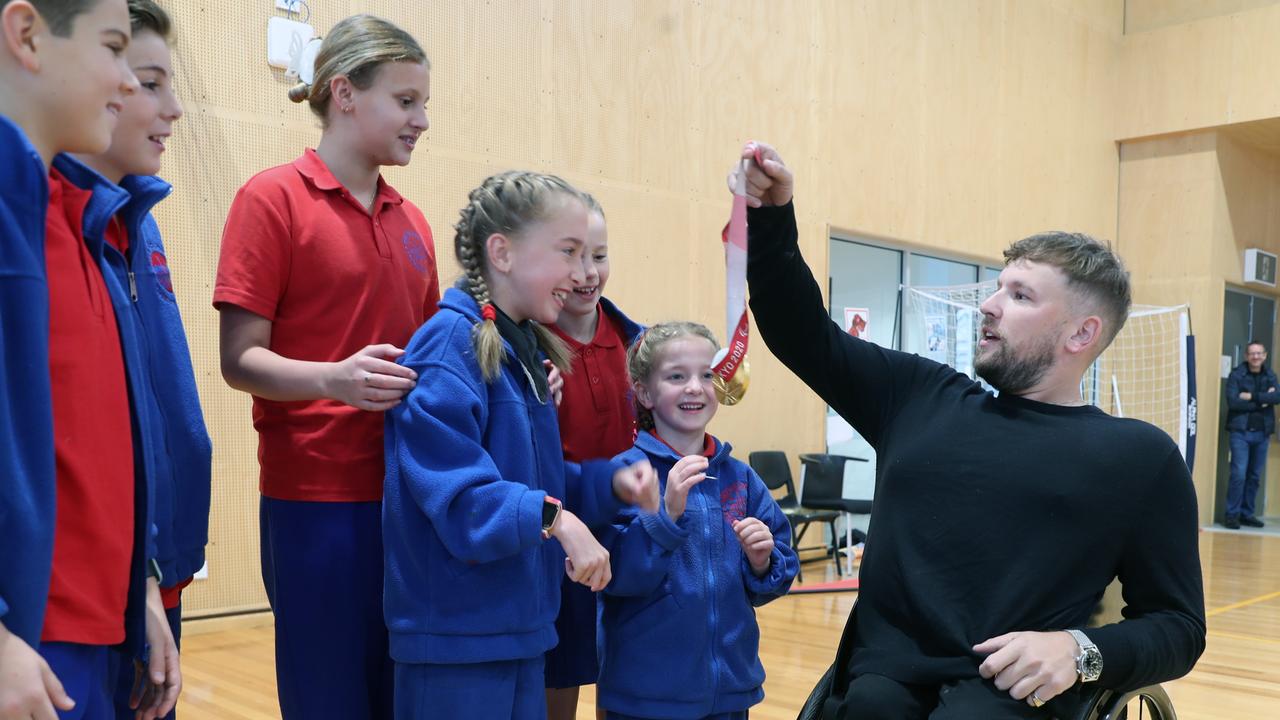 Dylan Alcott shows off his gold medal to students at Port Melbourne Primary on Tuesday. Picture: NCA NewsWire / David Crosling