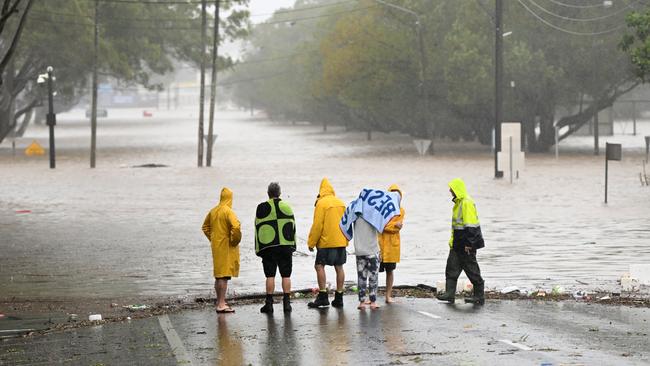 Lismore residents inspect a flooded road on March 30, 2022. Picture: Dan Peled/Getty Images