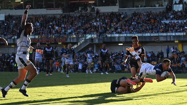 Cowboys halfback Scott Drinkwater dives over to score against Wests Tigers